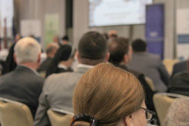 Video konferansı sırasında konferans salonunda ya da salonda oturan iş adamları 