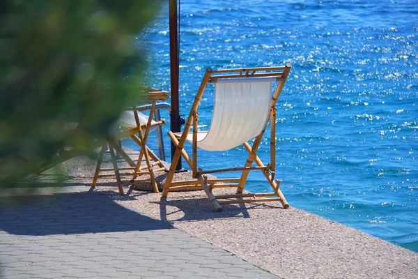 Two chairs by the sea. the chair is on the beach at the seaside