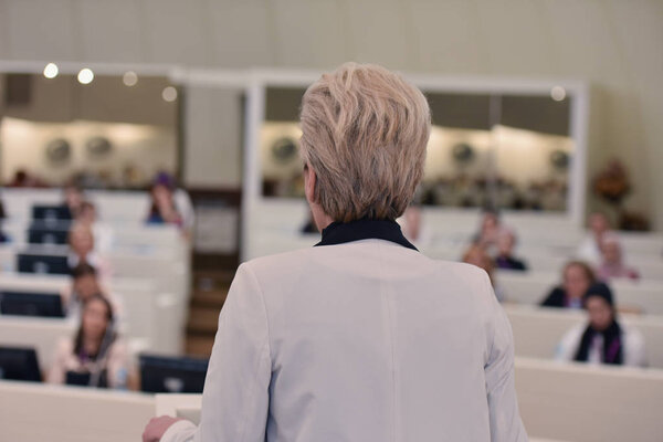 Business woman speaking at Conference. Audience at the conferenc