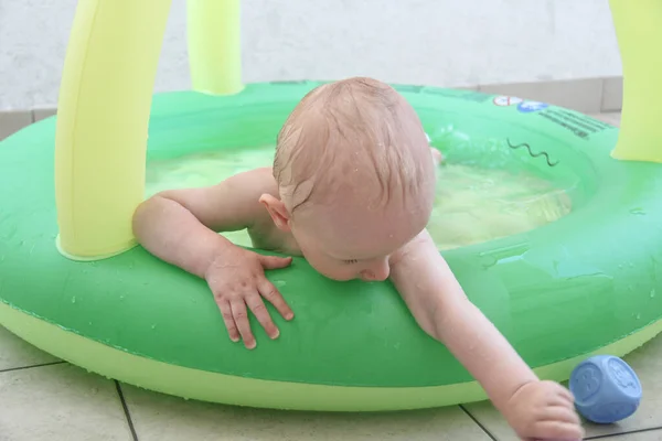 Beautiful one year baby boy playing in the swimming pool — 스톡 사진