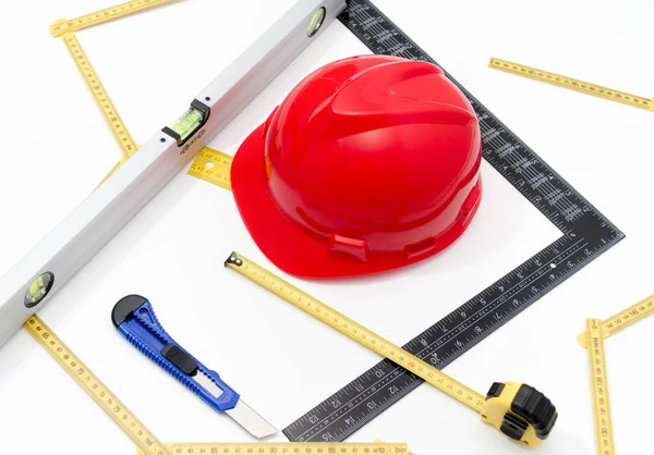 Helmet and tools for construction drawings and buildings — Stock Photo, Image