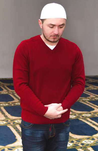 Young muslim man showing Islamic prayer