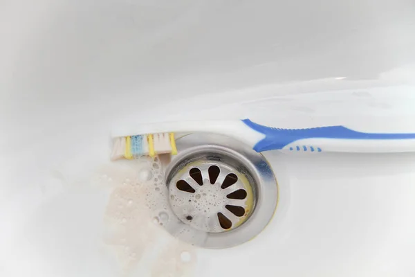 Blood and toothpaste on the toothbrush — Stock Photo, Image