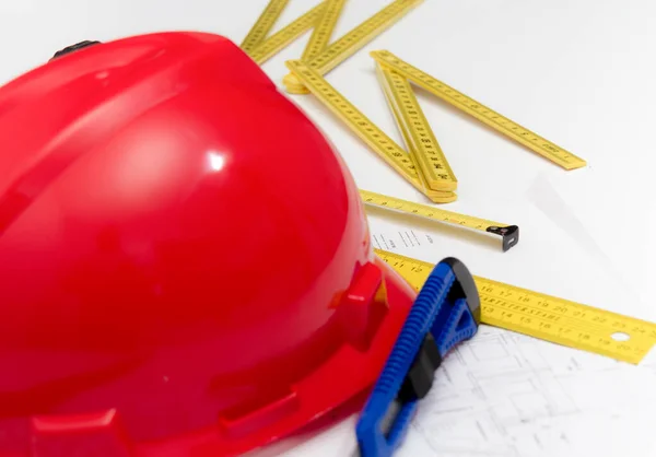 Helmet and tools for construction drawings and buildings — Stock Photo, Image