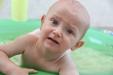 Güzel erkek bebek oyun alanında oynuyor.