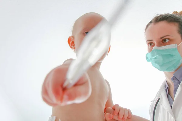 One year old sick baby boy at the young female doctor — Stok fotoğraf