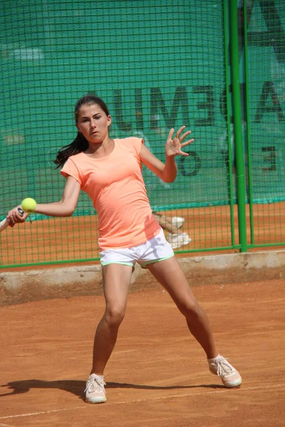 Όμορφη νεαρή κοπέλα σε ανοικτό γήπεδο τένις παίζει τένις — Φωτογραφία Αρχείου