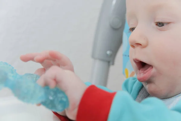 Cute little baby boy is playing with toys — Zdjęcie stockowe