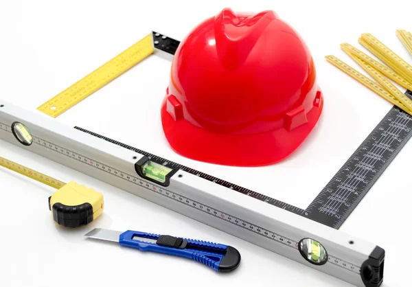 Helmet and tools for construction drawings and buildings — Stock Photo, Image