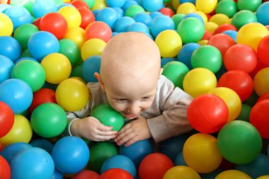 Güzel erkek bebek oyun alanında oynuyor.