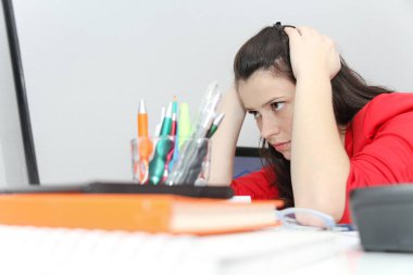 Businesswoman frustated with work, has a lot of work at the offi