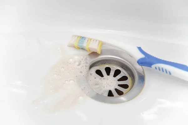 Blood and toothpaste on the toothbrush — Stock Photo, Image