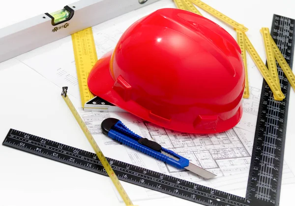 Helmet and tools for construction drawings and buildings — Stock Photo, Image