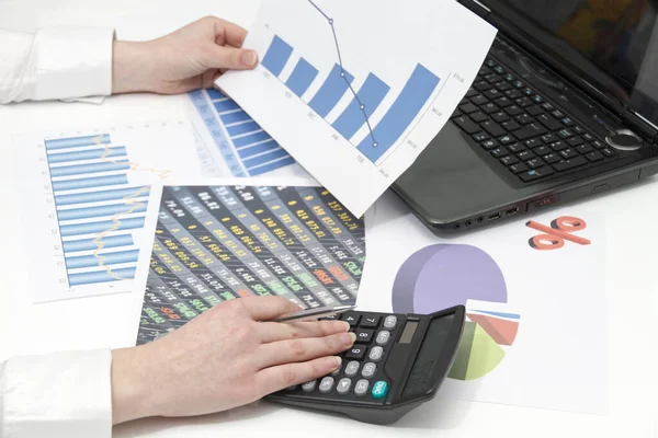 Stock image Young businesswoman calculating financial documents