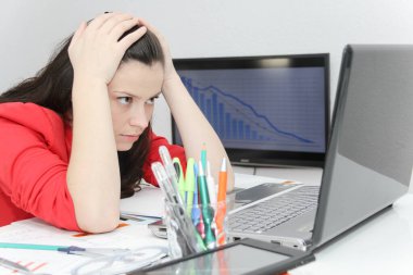 Businesswoman frustated with work, has a lot of work at the offi