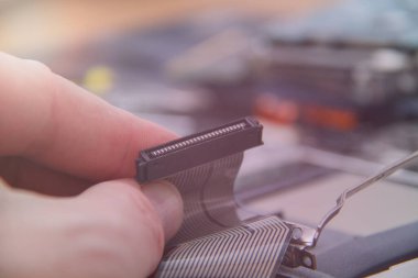 Computer service. Man repairing notebook at the table