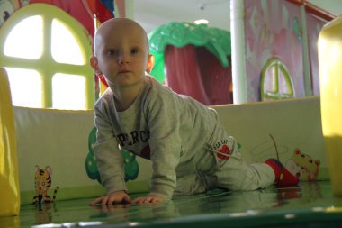 Güzel erkek bebek oyun alanında oynuyor.