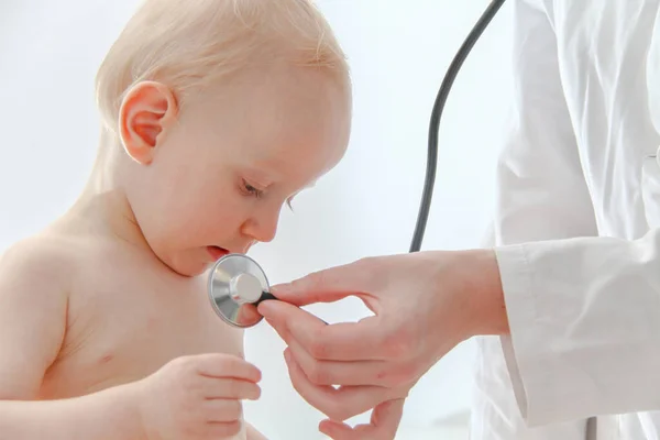 One year old sick baby boy at the young female doctor — Stok fotoğraf