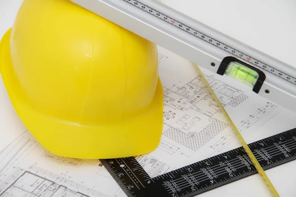 Helmet and tools for construction drawings and buildings — Stock Photo, Image