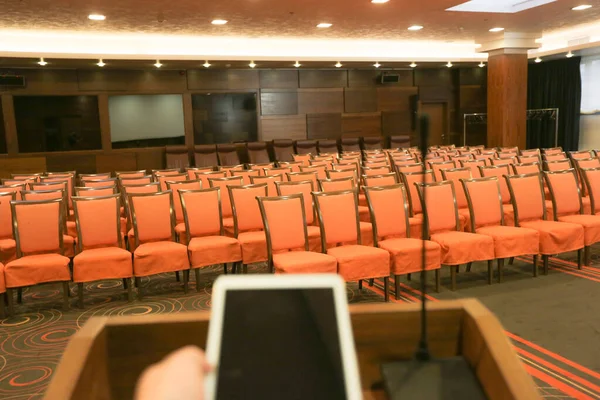 Rostrum with microphone and ipad  in conference hall — Stock Photo, Image