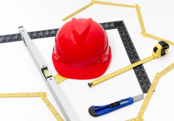 Helmet and tools for construction drawings and buildings — Stock Photo, Image