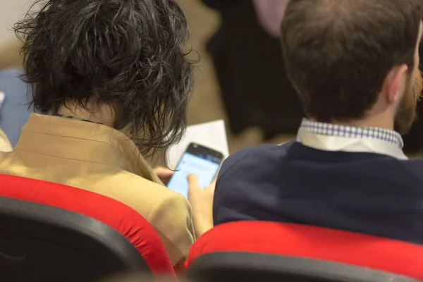 Durante la conferencia de negocios gente de negocios usando smatphone — Foto de Stock