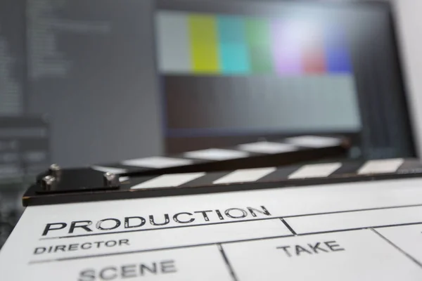 Movie clapper and editing room in background — Stock Photo, Image
