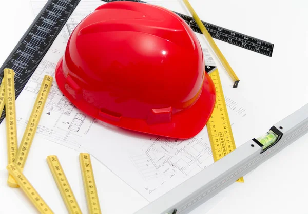 Helmet and tools for construction drawings and buildings — Stock Photo, Image