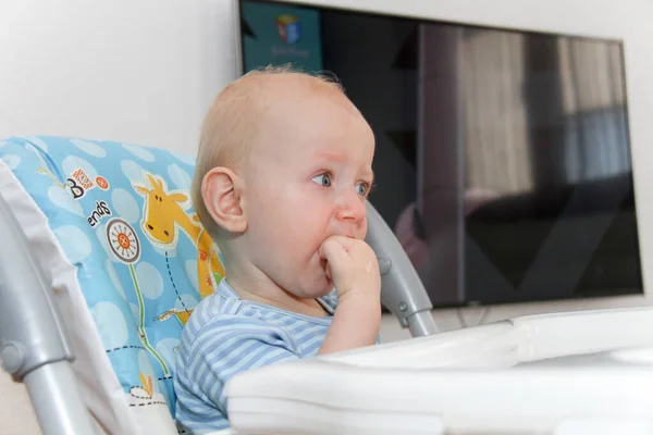 Один год Младенец смотрит мультики по телевизору и играет — стоковое фото