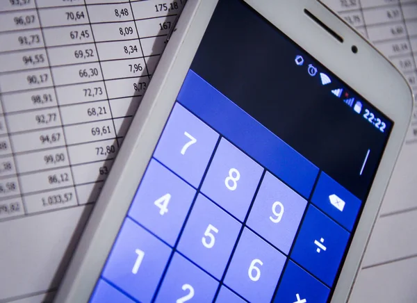 A calculator next to financial documents — Stock Photo, Image