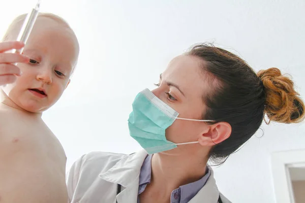 One year old sick baby boy at the young female doctor — Stock Fotó