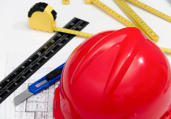 Helmet and tools for construction drawings and buildings — Stock Photo, Image