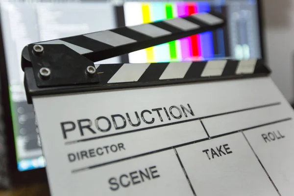Movie clapper and editing room in background — Stock Photo, Image