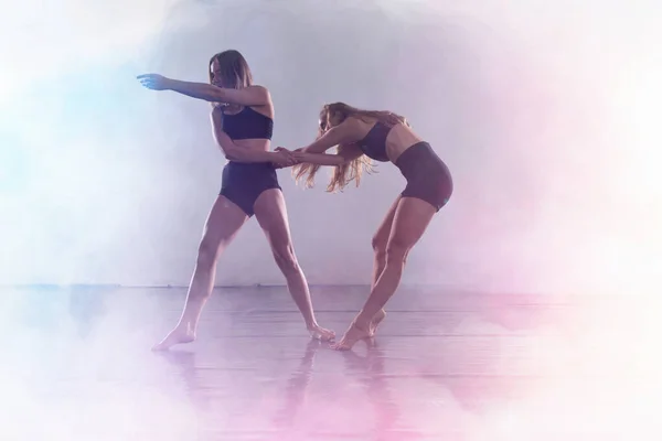 Two Young modern dancers dancing in the studio. Sport, dancing a — Stock Photo, Image