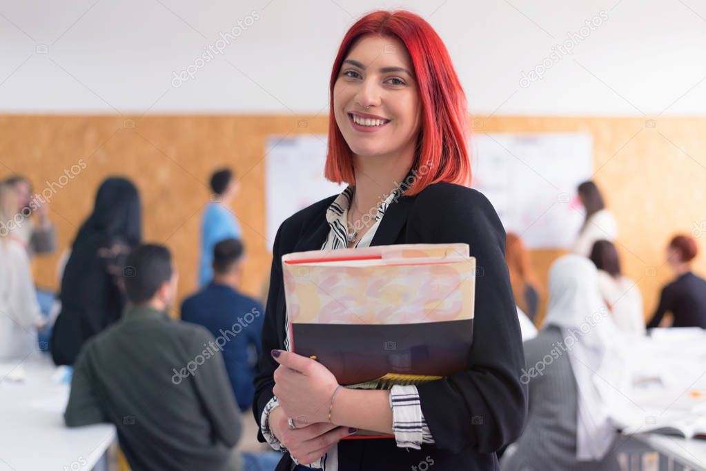 Beautiful positiv female student smiling at camera, standing in 