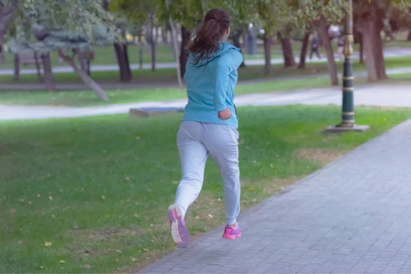 Mujer joven corriendo al aire libre en la carretera urbana. Mujer joven — Foto de Stock