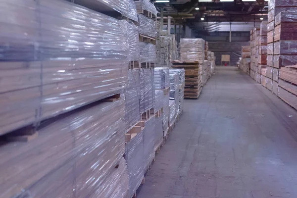 Timber Flooring Factory. Pile of cut wood in factory storage war