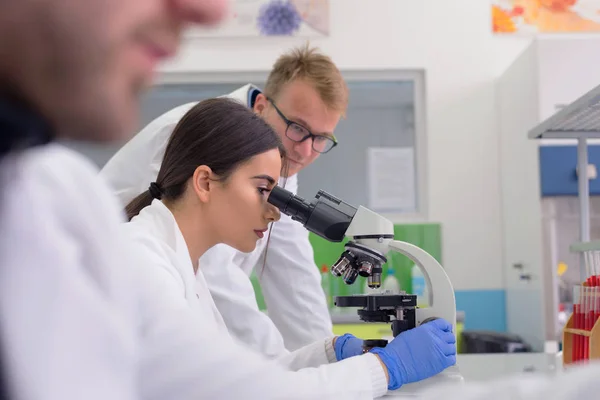 Group of  Laboratory scientists working at lab with test tubes,