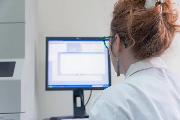 Young female Laboratory scientist working at lab with test tubes