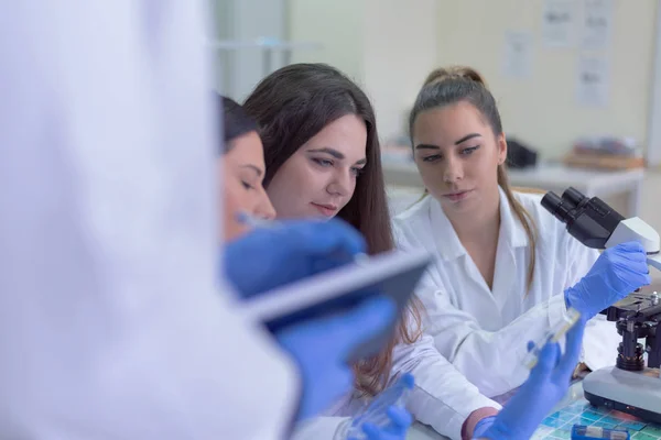 Group of  Laboratory scientists working at lab with test tubes,