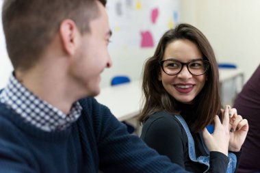 Bir grup üniversite bilişim teknolojisi öğrencisi pratik dersleri üzerinde çalışıyor. Therir bilgisayarının yanında oturup ders sırasında çözüm aramak..