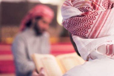 İki katır etnik dindar genç insan birlikte Kur 'an okuyup namaz kılıyorlar. Camide namaz kılan bir grup müslüman..