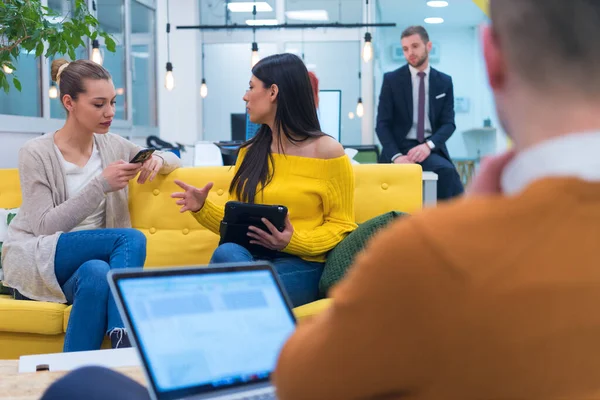 Multiracial young creative people in modern office. Group of young business people are working together with laptop, tablet, smart phone, notebook. Successful hipster team in coworking. Freelancers.