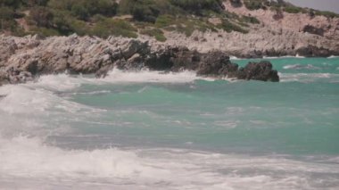 Boş bir sahile vuran dalgalara yakın çekim, yavaş çekim.