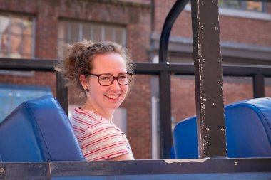 VANCOUVER - MAY 06 2019: Downtown Vancouver Canada. Bus Transportation System on May 06, 2019 in Vancouver, great accessibility for visitors,young woman and the interior of the hop on hop off bus