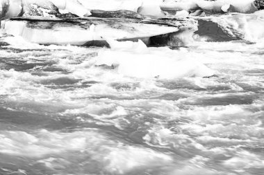 Jokulsarlon buzul gölünün soğuk sularında yüzen buzdağları. Vatnajokull Ulusal Parkı, İzlanda 'nın güneydoğusunda bir yol gezisi sırasında, klasik siyah beyaz