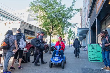 VANCOUVER - MAY 05 2019: Chinatown, Vancouver Canada. Homeless people in Chinatown on the street during a flea market, Homeless walking on the street
