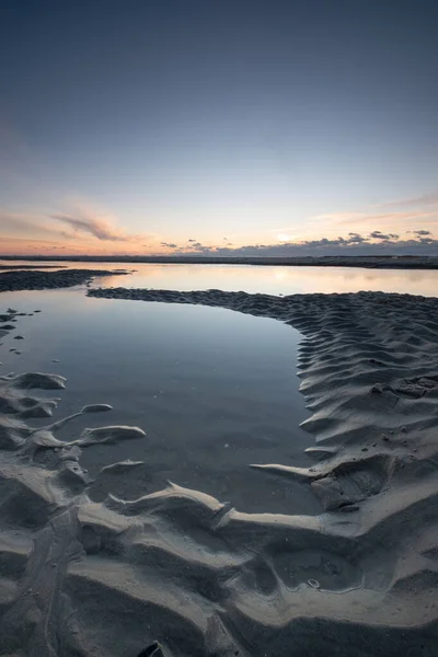 Tranquil colorful sunset over sea, viewed from the dutch coast. The Netherlands