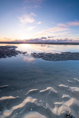 Tranquil colorful sunset over sea, viewed from the dutch coast. The Netherlands