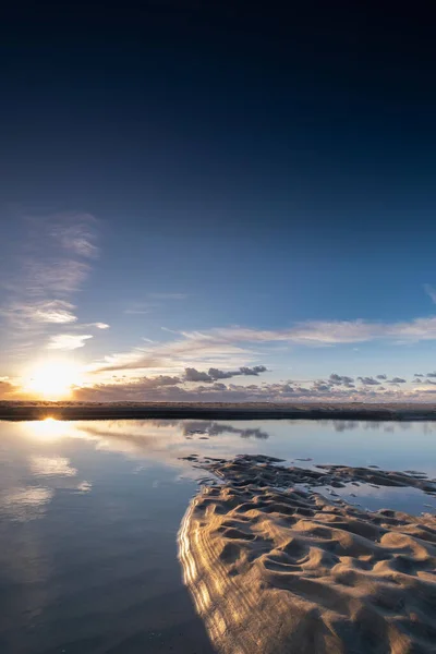 Tranquil colorful sunset over sea, viewed from the dutch coast. The Netherlands